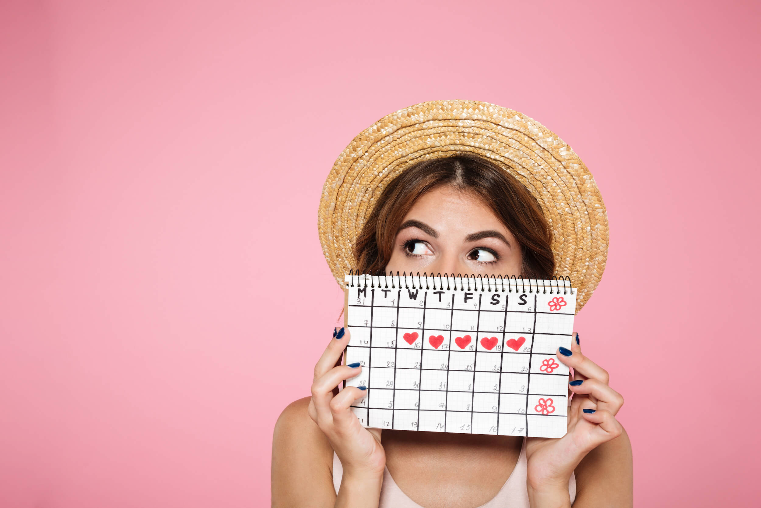 a girl with a straw hat holding a calendar